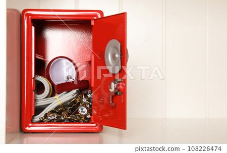 Open red steel safe with money and jewelry on shelf. Space for text Open red steel safe with money and jewelry on shelf. Space for text 108226474