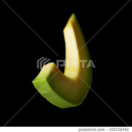 Slice of fresh avocado on black background 108226492
