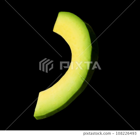 Slice of fresh avocado on black background Slice of fresh avocado on black background 108226493