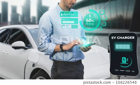Businessman check battery status from smartphone hologram. Peruse 108226548