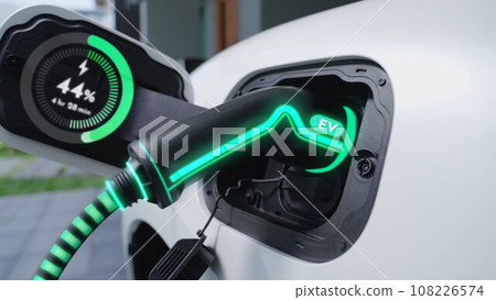 Closeup EV charger from home charging station recharging electric car. Peruse Closeup EV charger from home charging station recharging electric car. Peruse 108226574