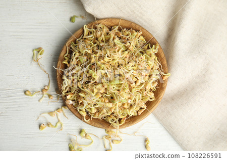Plate with sprouted green buckwheat on white wooden table, flat lay Plate with sprouted green buckwheat on white wooden table, flat lay 108226591