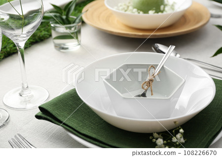 Stylish tableware and plants on table. Festive setting 108226670