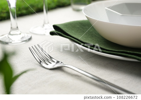 Elegant fork on table, closeup. Festive setting Elegant fork on table, closeup. Festive setting 108226672