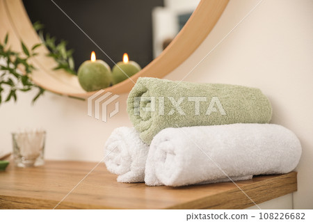 Fresh towels on wooden table in bathroom 108226682