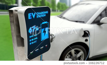 Electric car connected to charging station at public car park Peruse Electric car connected to charging station at public car park Peruse 108226712