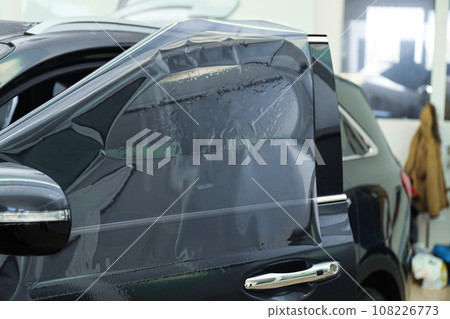 Car window covered with tinting foil, closeup Car window covered with tinting foil, closeup 108226773