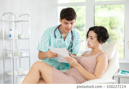 female patient documents signing 108227214