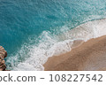Turkish Sea, top view. Kaputas Beach in Turkey. Beautiful waves roll over the sandy beach. Blue sea and yellow sand. Beach near the town of Cash in Turkey. Copy space 108227542