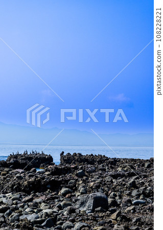 Futagoiwa, a sightseeing spot of wild birds perched on lava towers and rocks with the Ariake Sea in the background Minamishimabara City, Nagasaki Prefecture Futagoiwa, a sightseeing spot of wild birds perched on lava towers and rocks with the Ariake Sea in the background Minamishimabara City, Nagasaki Prefecture 108228221