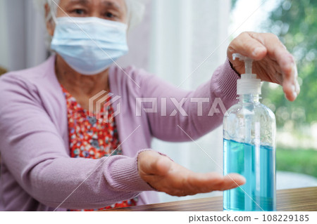 Asian senior woman press blue alcohol sanitizer gel for washing hand protect infection coronavirus. 108229185