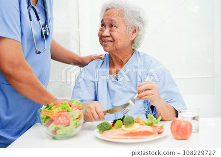 Asian Nutritionist holding healthy food for patient in hospital, nutrition and vitamin. 108229727