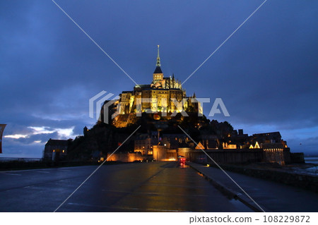 Mont Saint-Michel, a world cultural heritage monastery located on a small island at dusk in the Bay of Saint-Malo in the Normandy region of France 108229872