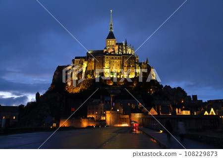 Mont Saint-Michel, a world cultural heritage monastery located on a small island at dusk in the Bay of Saint-Malo in the Normandy region of France 108229873