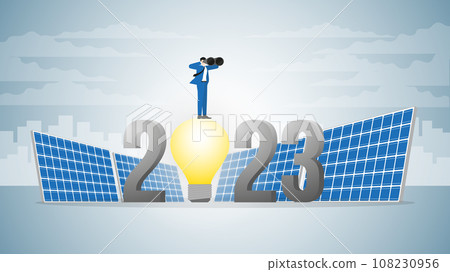 Vision businessman uses binoculars on 2023 light bulb powered by solar cells. 108230956