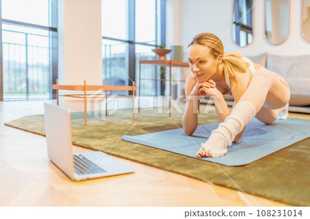 caucasian woman attending online yoga lesson 108231014