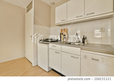 a very clean kitchen with white cabinets and stainless steel appliances on the counter top in front of the dishwasher 108231121