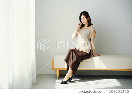 A woman sitting at the window 108231230