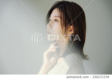 A woman standing by the window 108231336