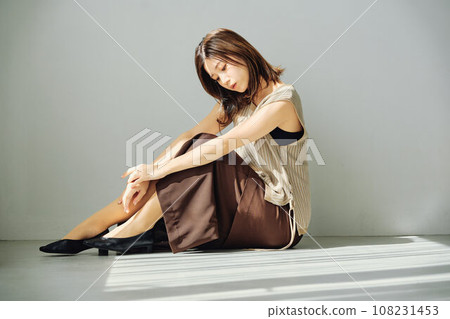 A woman sitting at the window A woman sitting at the window 108231453