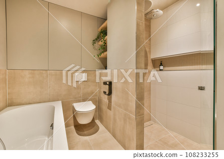 a bathroom with a toilet, sink and bathtub in the middle of the room there is a mirror on the wall 108233255