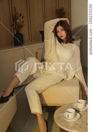 A woman relaxing in the room A woman relaxing in the room 108233526