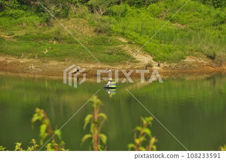 Fisherman at the dam lake of Nanakita Dam Fisherman at the dam lake of Nanakita Dam 108233591