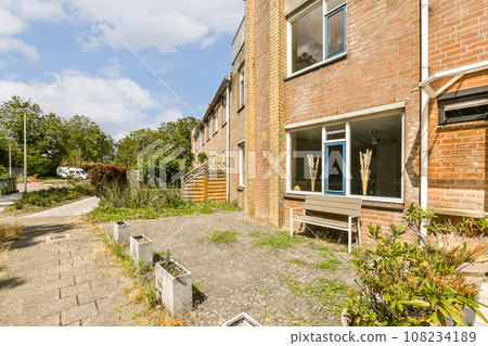 an outside area with some plants and bushes in the fore - eyed view, as seen from another side window 108234189