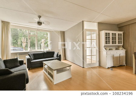 a living room with couches, coffee table, and tv in the center of the room is very clean 108234196