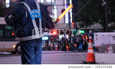 Metropolitan Police Department police officer directing traffic at a scrambled intersection with a guide rod Metropolitan Police Department police officer directing traffic at a scrambled intersection with a guide rod 108234489