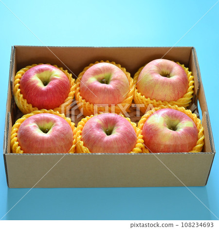 beautiful pink apple in the box on blue background 108234693
