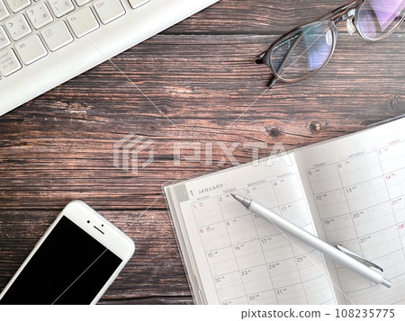 January schedule book open on the desk 108235775