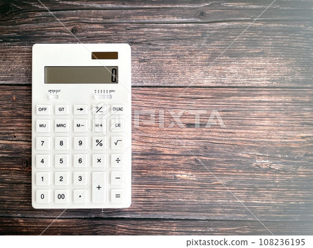 white calculator on wooden table 108236195