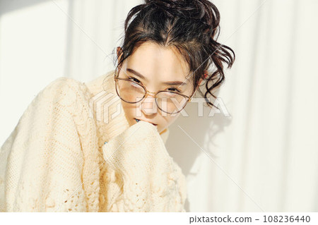Portrait of a woman in white knitwear 108236440