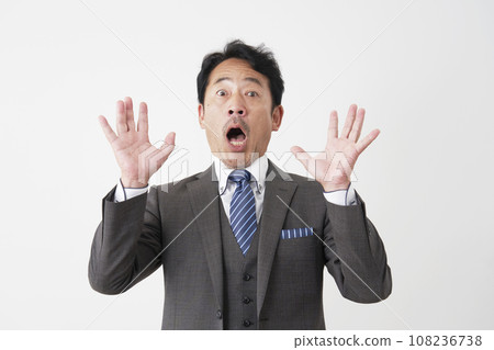 Surprised middle-aged businessman white background Surprised middle-aged businessman white background 108236738