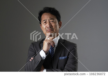 Crying middle-aged businessman black background Crying middle-aged businessman black background 108236872