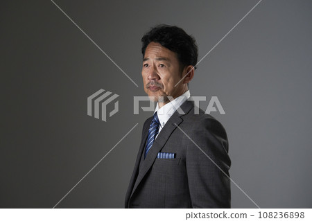 Portrait of a middle-aged businessman, black background Portrait of a middle-aged businessman, black background 108236898