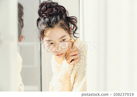 Portrait of a woman in white knitwear 108237019