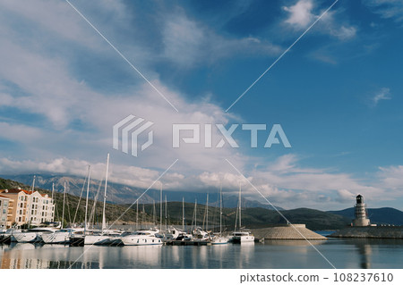 Row of sailing yachts are moored at Lustica Bay near the lighthouse. Montenegro 108237610