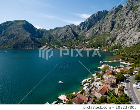 Red roofs of a resort town on the seashore at the foot of a mountain range. Drone Red roofs of a resort town on the seashore at the foot of a mountain range. Drone 108237805