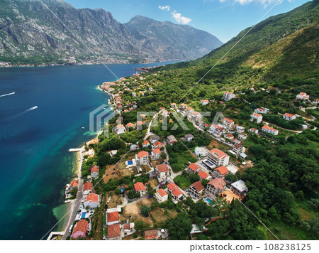 Coast of Dobrota on the shore of the Bay of Kotor at the foot of the mountains. Montenegro Coast of Dobrota on the shore of the Bay of Kotor at the foot of the mountains. Montenegro 108238125