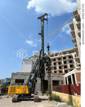 Drilling rig drills the ground near the construction of a multi-storey building 108238191