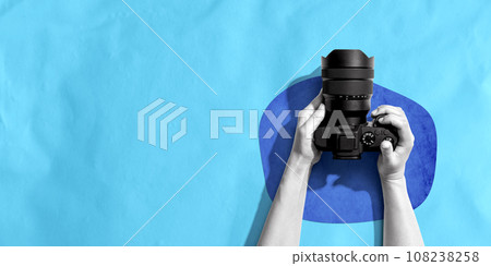 Person holding a SLR camera 108238258