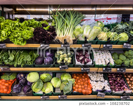 Fresh vegetables lie in boxes on stalls in the market Fresh vegetables lie in boxes on stalls in the market 108238702
