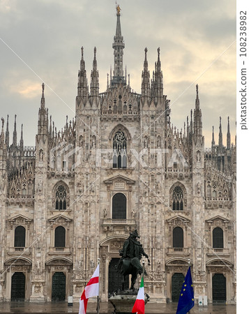 Statue of King Victor Emmanuel II in front of the Duomo Cathedral against a cloudy sky. Milan, Italy Statue of King Victor Emmanuel II in front of the Duomo Cathedral against a cloudy sky. Milan, Italy 108238982