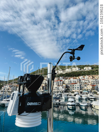 Small weather station with cup anemometer and weathervane at the pier 108239028