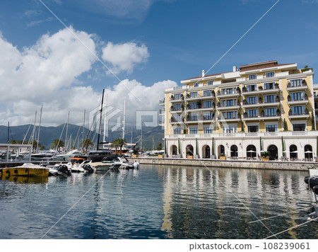 Embankment of the Regent Hotel with green trees in tubs near the marina with yachts 108239061
