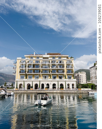 Motorboat is sailing across the sea to the Regent Hotel. Porto, Montenegro 108239081