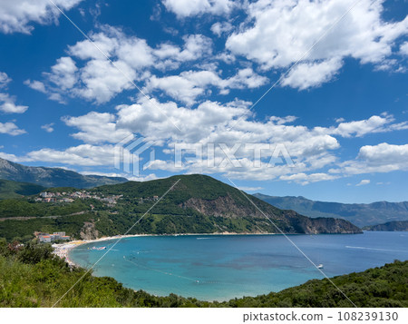 Blue bay in a valley between high mountains against a cloudy sky Blue bay in a valley between high mountains against a cloudy sky 108239130