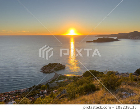 View from the mountain to the island of Sveti Stefan at sunset. Montenegro View from the mountain to the island of Sveti Stefan at sunset. Montenegro 108239133